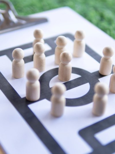 Football tactical clipboard on top of green football field.
