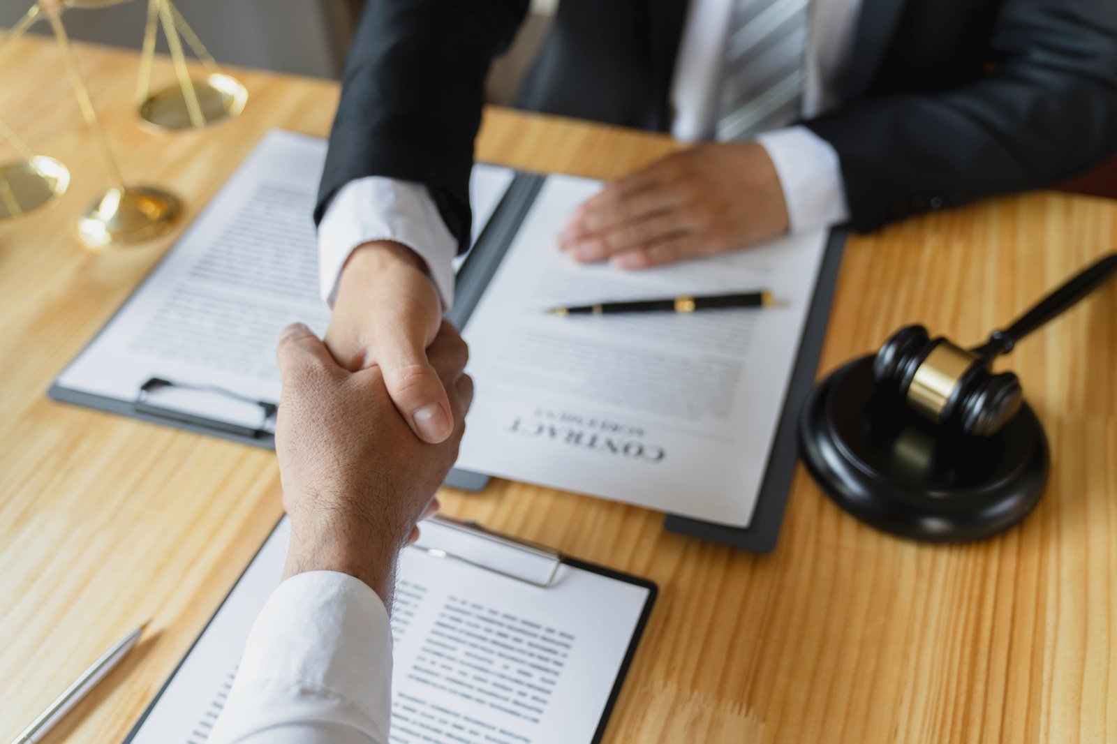 Lawyers shake hands with business people to seal a deal with partner lawyers. or a lawyer discussing